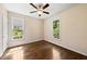 Bright bedroom featuring hardwood floors, neutral walls, and a ceiling fan at 311 Rassie Crabtree Rd, Rougemont, NC 27572