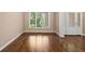 Inviting foyer with hardwood floors, a decorative front door, and large window with natural light at 311 Rassie Crabtree Rd, Rougemont, NC 27572