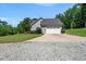 Ranch-style house with a two-car garage and long driveway at 311 Rassie Crabtree Rd, Rougemont, NC 27572