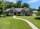 Attractive single-Gathering home with stone detailing, landscaping, and a walkway at 311 Rassie Crabtree Rd, Rougemont, NC 27572