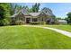 Lovely single-Gathering home featuring stone accents, a paved walkway, and a well-kept lawn at 311 Rassie Crabtree Rd, Rougemont, NC 27572
