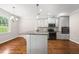 Modern kitchen featuring gray cabinets, stainless steel appliances, and a large island with granite countertops at 311 Rassie Crabtree Rd, Rougemont, NC 27572
