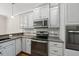 Well-equipped kitchen featuring stainless steel appliances, granite countertops, and white cabinets at 311 Rassie Crabtree Rd, Rougemont, NC 27572