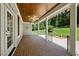 Inviting covered porch with brick flooring, ceiling fan and views of a well-manicured lawn at 311 Rassie Crabtree Rd, Rougemont, NC 27572