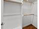Spacious walk-in closet with wood shelving and ample storage space for an organized wardrobe at 311 Rassie Crabtree Rd, Rougemont, NC 27572