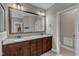A bathroom showcases double vanities with granite countertops and a framed mirror at 3111 Virginia Pine Ln, Apex, NC 27539