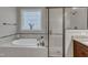 Relaxing bathroom with soaking tub, glass shower, and elegant tiled accents at 3111 Virginia Pine Ln, Apex, NC 27539
