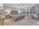 Spacious main bedroom featuring tray ceiling, and large windows with backyard views at 3111 Virginia Pine Ln, Apex, NC 27539