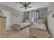 A coastal-themed bedroom features two twin beds, a ceiling fan, and beach-inspired decor on the walls at 3111 Virginia Pine Ln, Apex, NC 27539