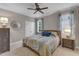 Cozy bedroom with neutral walls, a ceiling fan, and a comfortable queen-sized bed with soft blue accents at 3111 Virginia Pine Ln, Apex, NC 27539