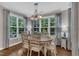 Bright dining room with hardwood floors, natural light, and elegant chandelier at 3111 Virginia Pine Ln, Apex, NC 27539
