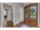 Inviting entryway with hardwood floors, a double wooden front door with glass inserts, and sidelight windows at 3111 Virginia Pine Ln, Apex, NC 27539