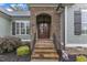 Charming front entrance with stone steps, arched stonework, and a welcoming double door at 3111 Virginia Pine Ln, Apex, NC 27539