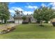A home with a beautiful green lawn, landscaping, and a two-car garage at 3111 Virginia Pine Ln, Apex, NC 27539