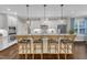 Charming kitchen with granite countertops, stainless steel appliances, and seating at the island at 3111 Virginia Pine Ln, Apex, NC 27539