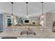 Gourmet kitchen with island sink, granite countertops, and open floor plan to living area at 3111 Virginia Pine Ln, Apex, NC 27539