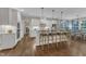 Modern kitchen with white cabinets, stainless steel appliances, and a breakfast bar with pendant lighting at 3111 Virginia Pine Ln, Apex, NC 27539