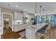 Stylish kitchen featuring a breakfast bar, stainless steel appliances, and bright natural lighting at 3111 Virginia Pine Ln, Apex, NC 27539