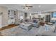 Open-concept living room with hardwood floors, built-in shelving, and seamless flow into the kitchen at 3111 Virginia Pine Ln, Apex, NC 27539