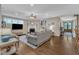Large living room with hardwood floors, a fireplace, built-in shelves, and a comfortable seating arrangement at 3111 Virginia Pine Ln, Apex, NC 27539