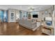 Spacious living room with hardwood floors, a fireplace, built-in shelves, and plenty of natural light at 3111 Virginia Pine Ln, Apex, NC 27539