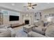 Comfortable living room featuring a fireplace, ceiling fan, and stylish decor with built-in shelves at 3111 Virginia Pine Ln, Apex, NC 27539