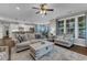 Bright living room with natural light, hardwood floors, and an open layout connected to dining and kitchen at 3111 Virginia Pine Ln, Apex, NC 27539