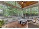 Inviting screened porch with comfortable seating, ceiling fan, and views of the backyard at 3111 Virginia Pine Ln, Apex, NC 27539
