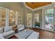 Cozy screened porch with ample seating and a view of the landscaped backyard with privacy at 3111 Virginia Pine Ln, Apex, NC 27539