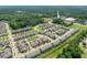 Aerial view of the community showcasing well-maintained homes, streets, and lush green spaces at 336 Skymont Dr, Holly Springs, NC 27540