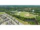Community aerial view highlights the homes, recreational areas, and picturesque pond at 336 Skymont Dr, Holly Springs, NC 27540
