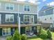 View of the back exterior with patio and balcony area, perfect for relaxing and entertaining at 336 Skymont Dr, Holly Springs, NC 27540
