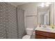 Cozy bathroom with a decorative shower curtain, classic vanity, and neutral color scheme at 336 Skymont Dr, Holly Springs, NC 27540
