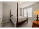 Bedroom with carpet, neutral walls, four poster bed, and ample natural light from the windows at 336 Skymont Dr, Holly Springs, NC 27540