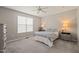 Cozy bedroom with large window, carpet floors, and neutral decor at 336 Skymont Dr, Holly Springs, NC 27540