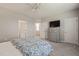 Neutral bedroom with gray carpet, large dresser, and convenient access to two closets and a bathroom at 336 Skymont Dr, Holly Springs, NC 27540