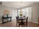 Cozy dining area with chandelier, bright natural light, and seating for four at 336 Skymont Dr, Holly Springs, NC 27540