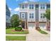 Charming townhome with gray siding, brick accents, well-kept lawn, and two-car garage in a desirable neighborhood at 336 Skymont Dr, Holly Springs, NC 27540