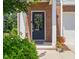 Inviting front door with brick surround, adorned with a wreath, leading to a welcoming entrance at 336 Skymont Dr, Holly Springs, NC 27540