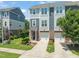 Charming townhome boasting a brick facade, attached garage, and manicured landscaping at 336 Skymont Dr, Holly Springs, NC 27540