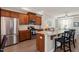 Charming kitchen features stainless appliances, granite counters, and breakfast bar seating at 336 Skymont Dr, Holly Springs, NC 27540