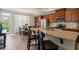 Bright kitchen with island seating, stainless appliances, and adjacent dining area at 336 Skymont Dr, Holly Springs, NC 27540