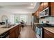 Well-appointed kitchen boasts stainless appliances, granite counters, and wood floors at 336 Skymont Dr, Holly Springs, NC 27540