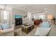 Open concept living room with kitchen view, comfortable seating, and TV at 336 Skymont Dr, Holly Springs, NC 27540