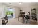 Bright and functional office space with a desk, shelving, and a sliding glass door to the outside at 336 Skymont Dr, Holly Springs, NC 27540