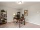 Comfortable home office with a wooden desk, shelving, and neutral tones for a productive workspace at 336 Skymont Dr, Holly Springs, NC 27540