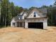 Two-story new construction home with a two-car garage and inviting covered porch in a lush wooded setting at 393 Abingdon Farms Dr, Selma, NC 27576