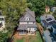 Aerial view of a two-story home featuring a screened porch, a fenced-in backyard with patio and firepit in a lovely neighborhood at 425 Morrison Ave, Raleigh, NC 27608