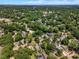 Drone shot of a residential neighborhood featuring homes nestled among mature trees and green spaces at 425 Morrison Ave, Raleigh, NC 27608