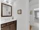 Well-lit bathroom with a wood vanity, white countertop, and view into hallway at 425 Morrison Ave, Raleigh, NC 27608